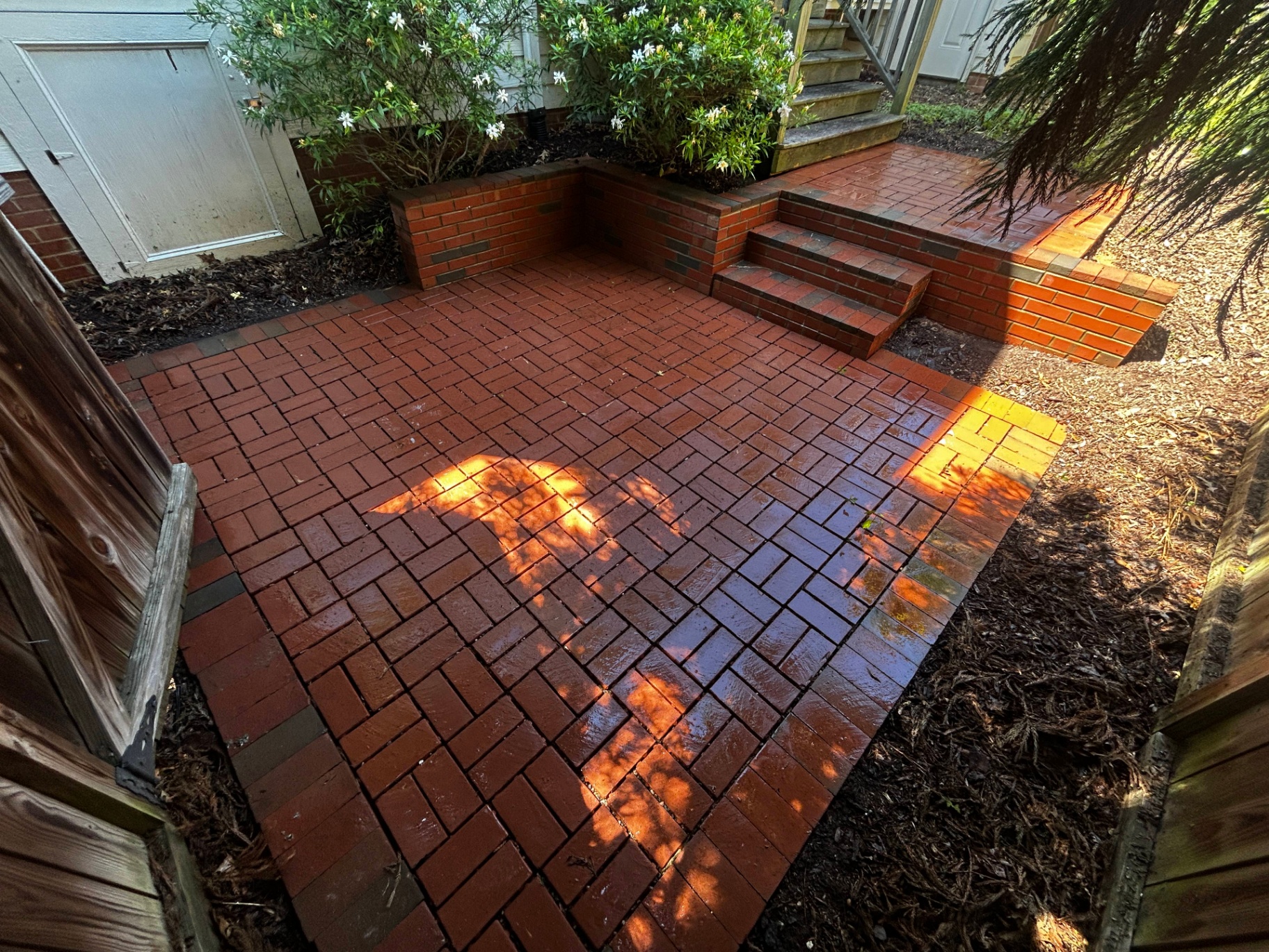 Freshly pressure-washed stone patio completed by Good Fellas