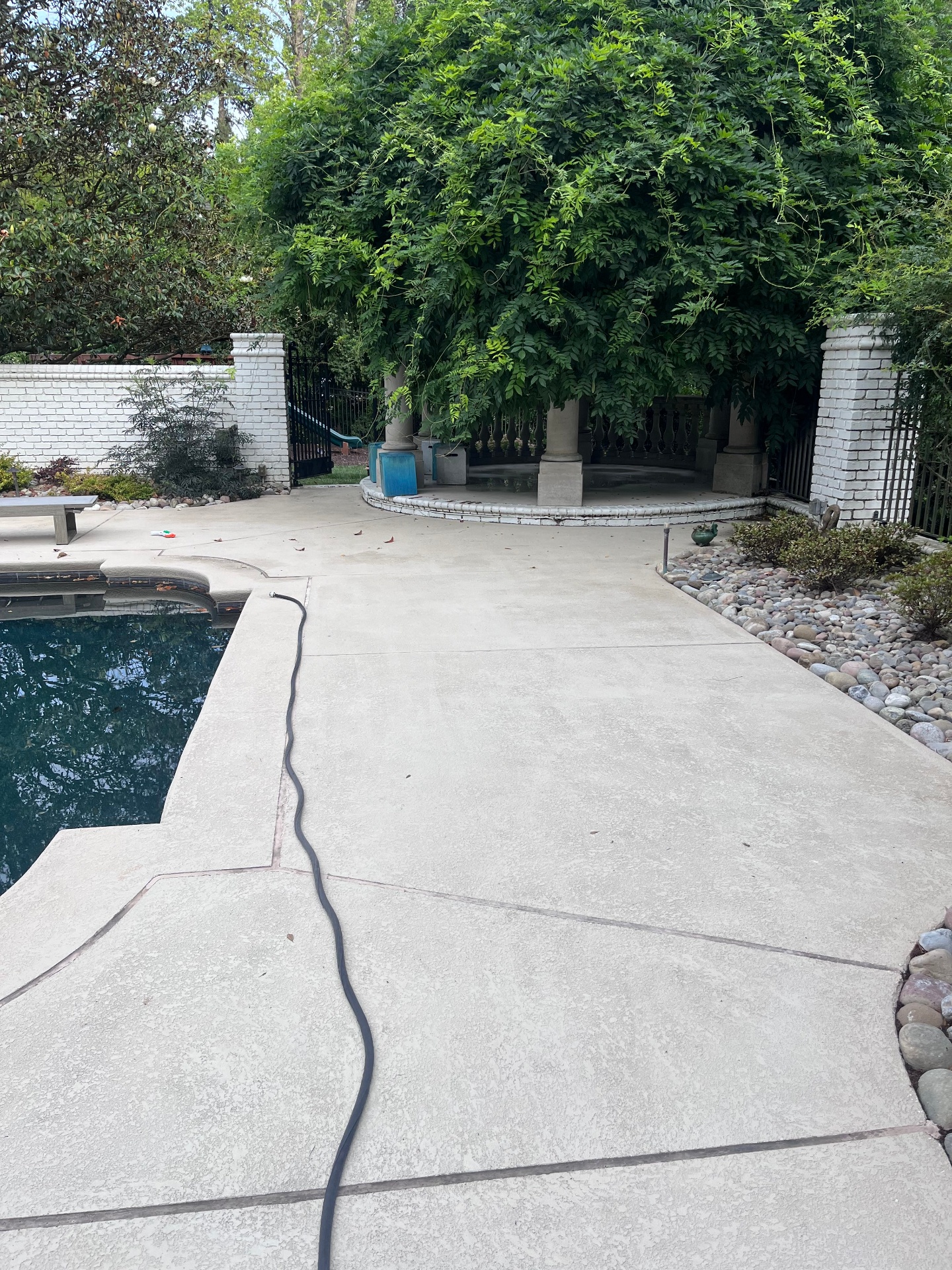 Clean concrete pool deck after pressure washing